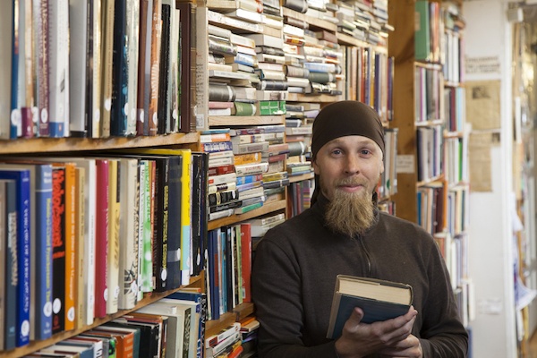 hipster with goatee in independent bookstore for marketing