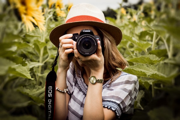 female photographer taking pics for online listings and free marketing