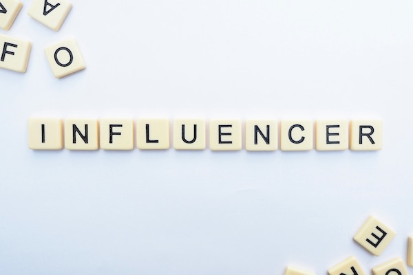 scrabble tiles spelling out influencer for local seo