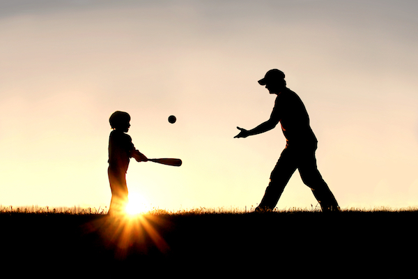 silhouette image of father and son playing baseball for work life balance