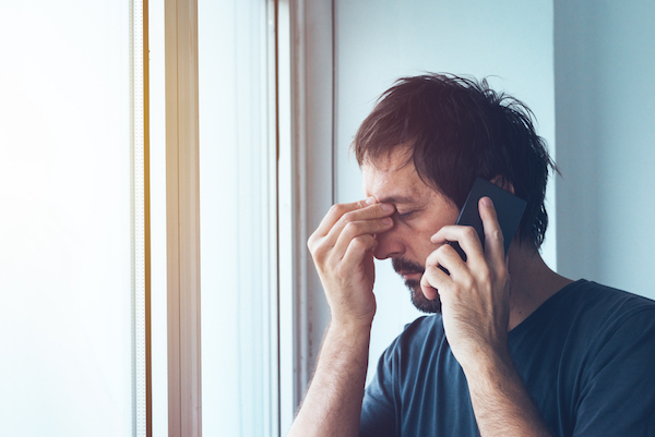 stressed out disheveled man calling on phone for work life balance