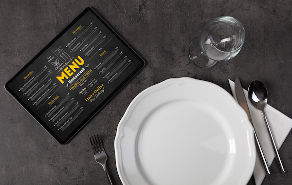 table setting with tablet displaying full online menu