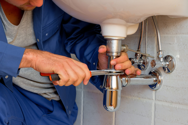 plumber fixing a sink for small business PR