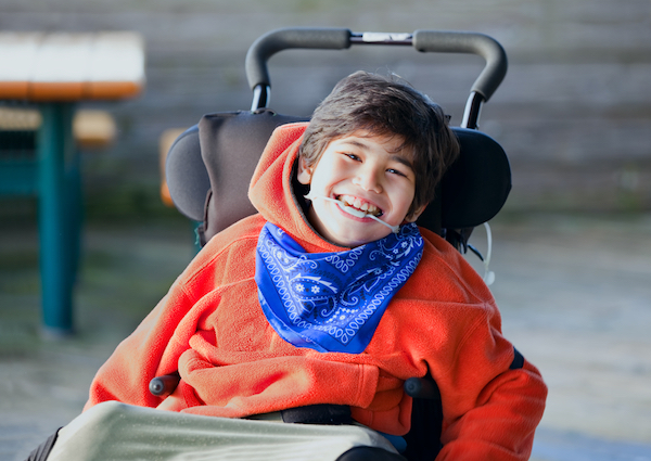 smiling boy in wheelchair for small business PR