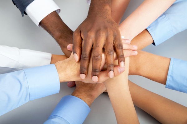 image of multiracial hands supporting each other for chamber of commerce