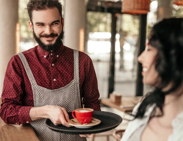 hipster barista giving good customer experience
