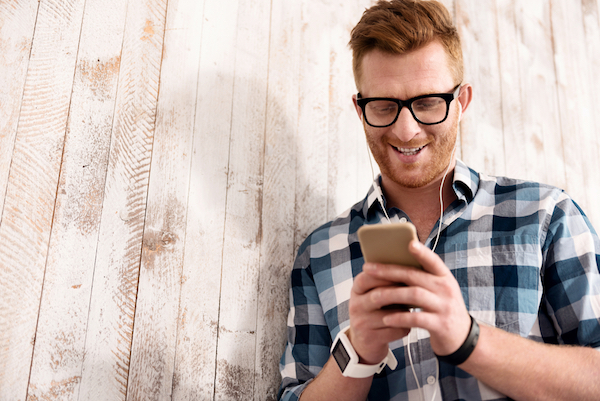 Hipster using email on smartphone for small business marketing