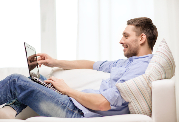 man reading a small business blog on laptop