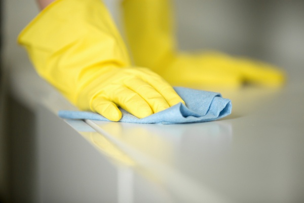 yellow rubber gloves sanitizing surfaces for small business