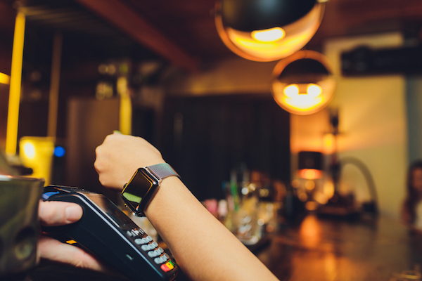 customer paying with a contactless payment wearable